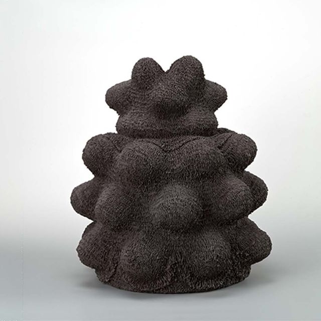 A black ceramic sculpture with texture
