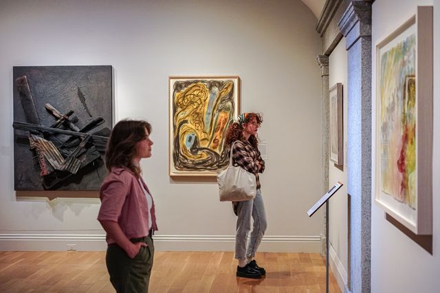 Two visitors standing in front of an artwork.