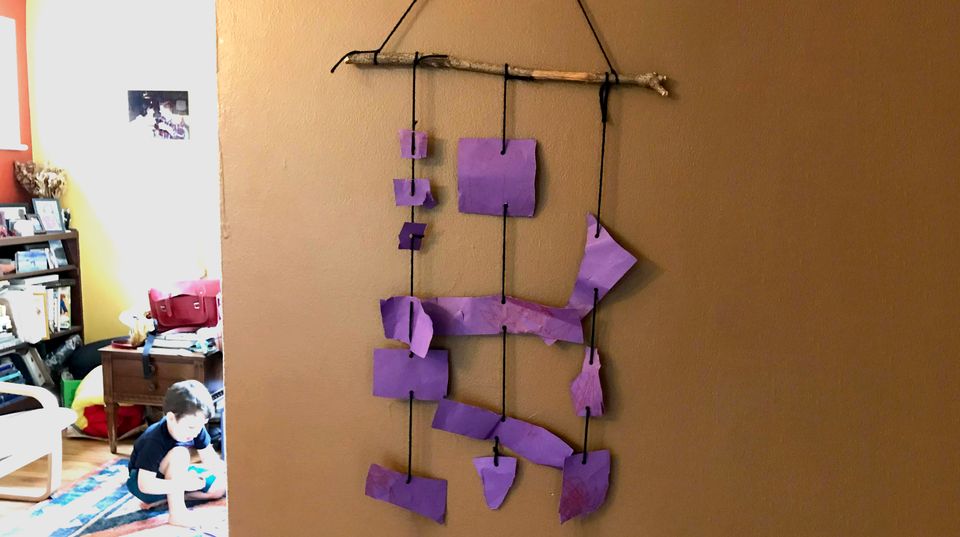 A photograph of a purple hanging mobile.
