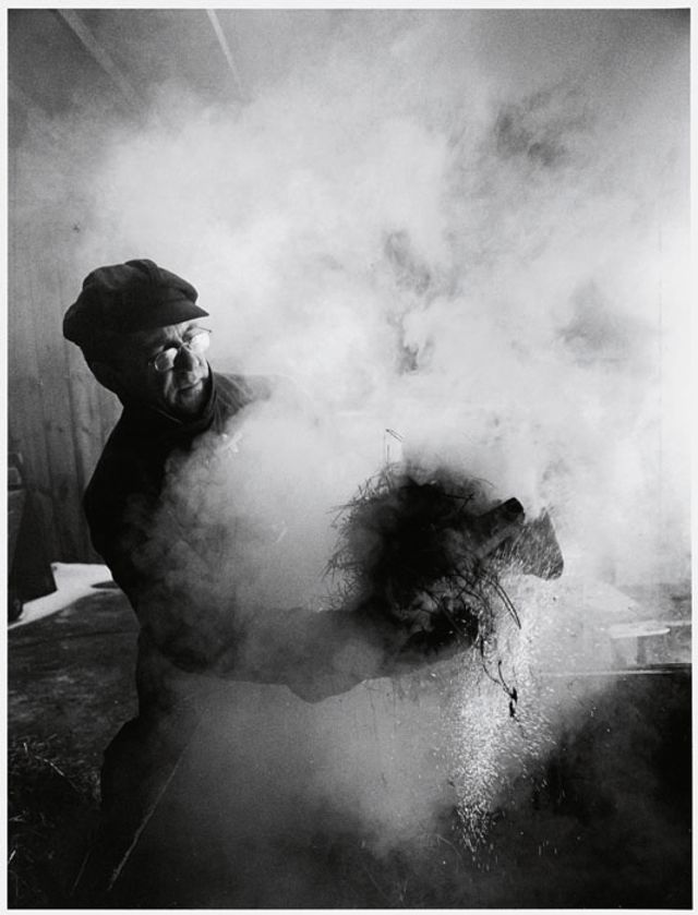 Black and White photograph of Wayne Higby in studio firing work.