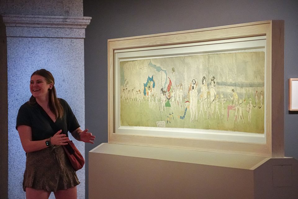 A visitor standing in front of an artwork.