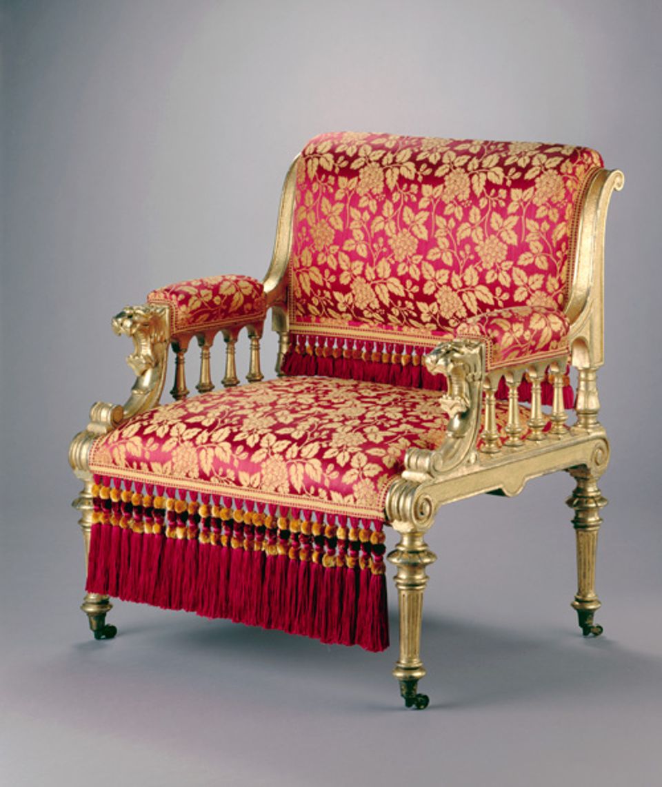 An image of a gilded ash armchair with gold accents and red upholstery.