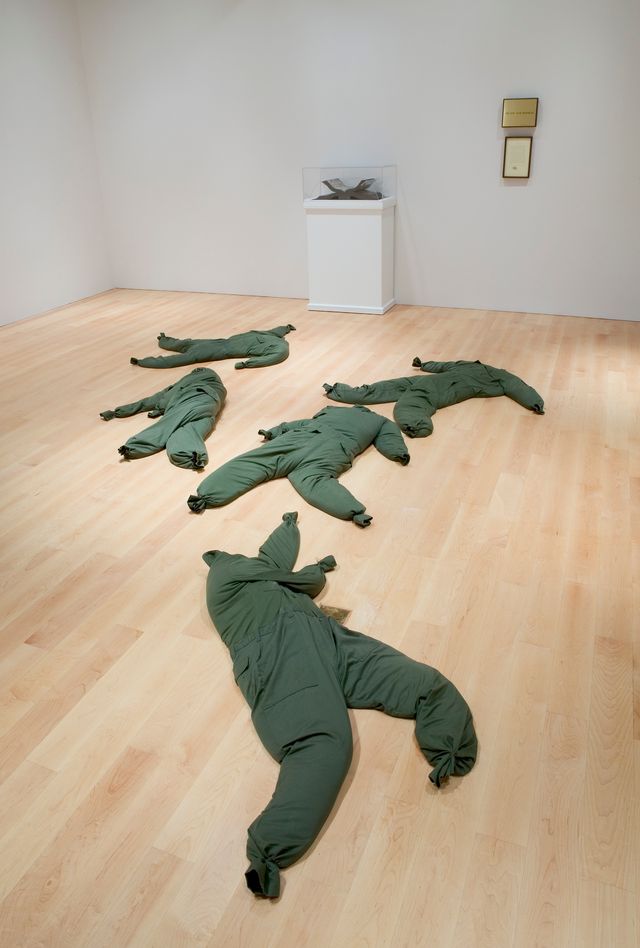 An image of green clothing laying on the gallery floor.