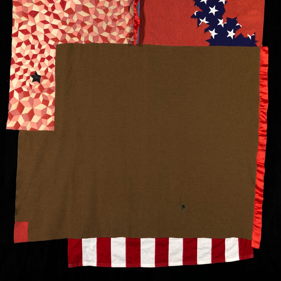 An image of a quilt made of multiple materials. 