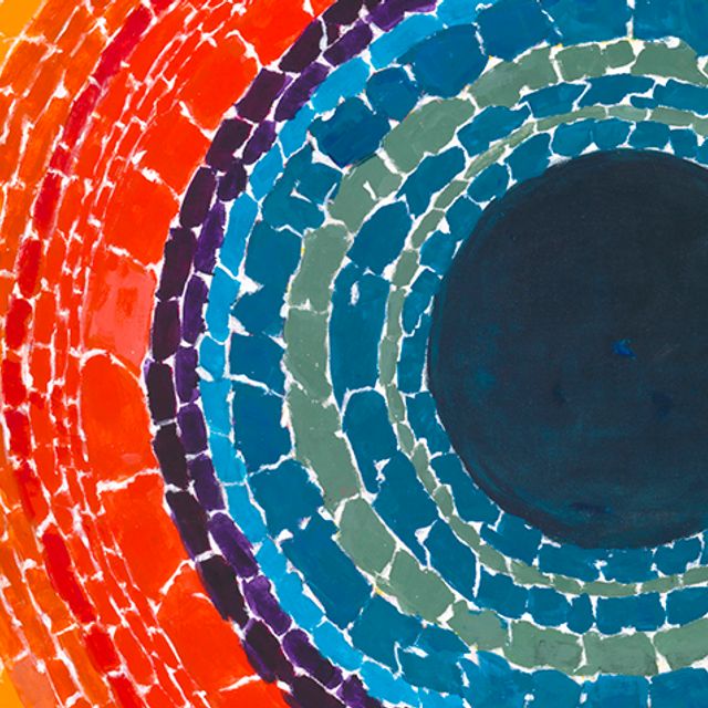 A detail of a vibrant painting with a dark navy blue circle on the right surrounded by concentric circles of reds, oranges, and yellow.