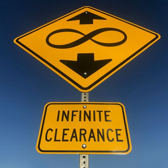 An image of a yield sign with an infinity symbol on it. 