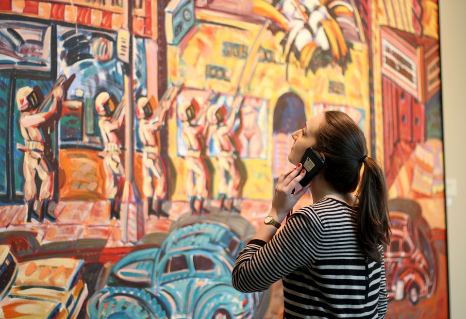 A woman listening to an audio tour on her phone