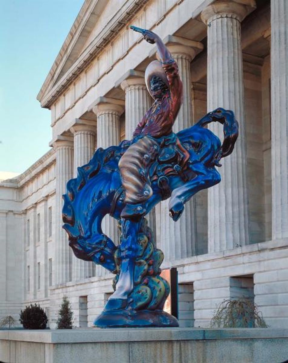 A photograph of Luis Jimenez's Vaquero, a cowboy sculpture, outside the Smithsonian American Art Museum.