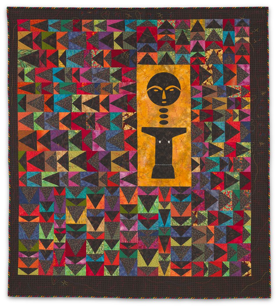 Patterned, multicolor quilt with a Akwabaa figure.