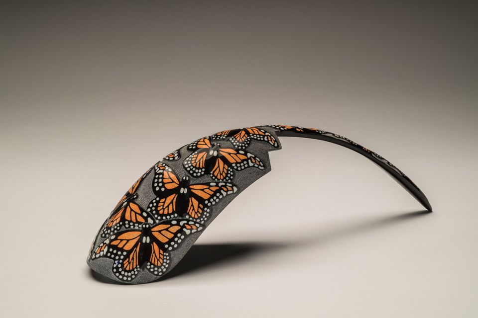 Fragment of a horn with monarch butterflies painted on it