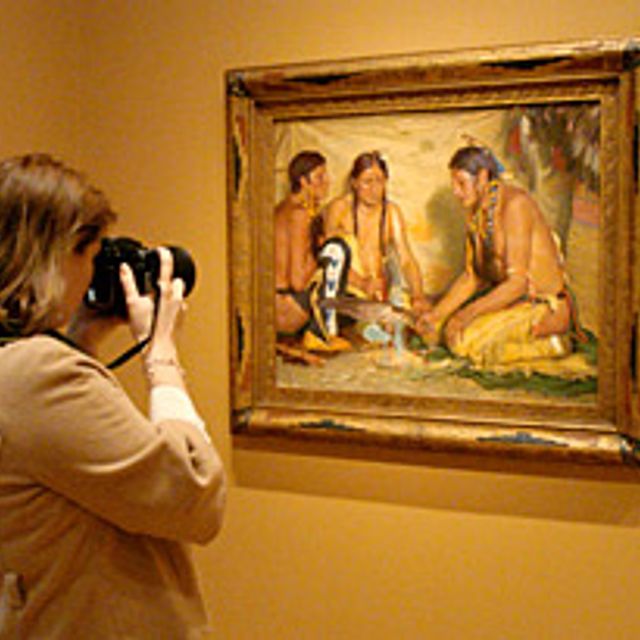 person taking a photo of an artwork