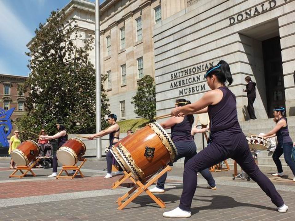 A photograph of Chinese drummers performing outside of the Smithsonian American Art Museum for the annual Cherry Blossom Festival