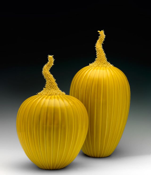 An image of two of Lee's prickly melons with a yellow glaze.