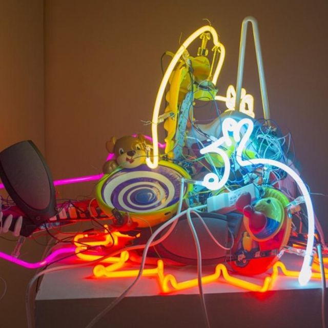 collection of neon lights with stuffed animals and computer parts bundled together