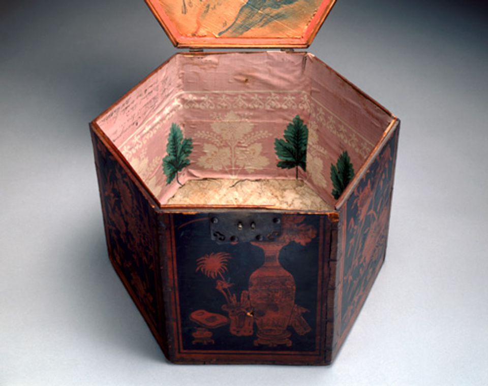 An image of a painted wood box with wallpaper inside of it.