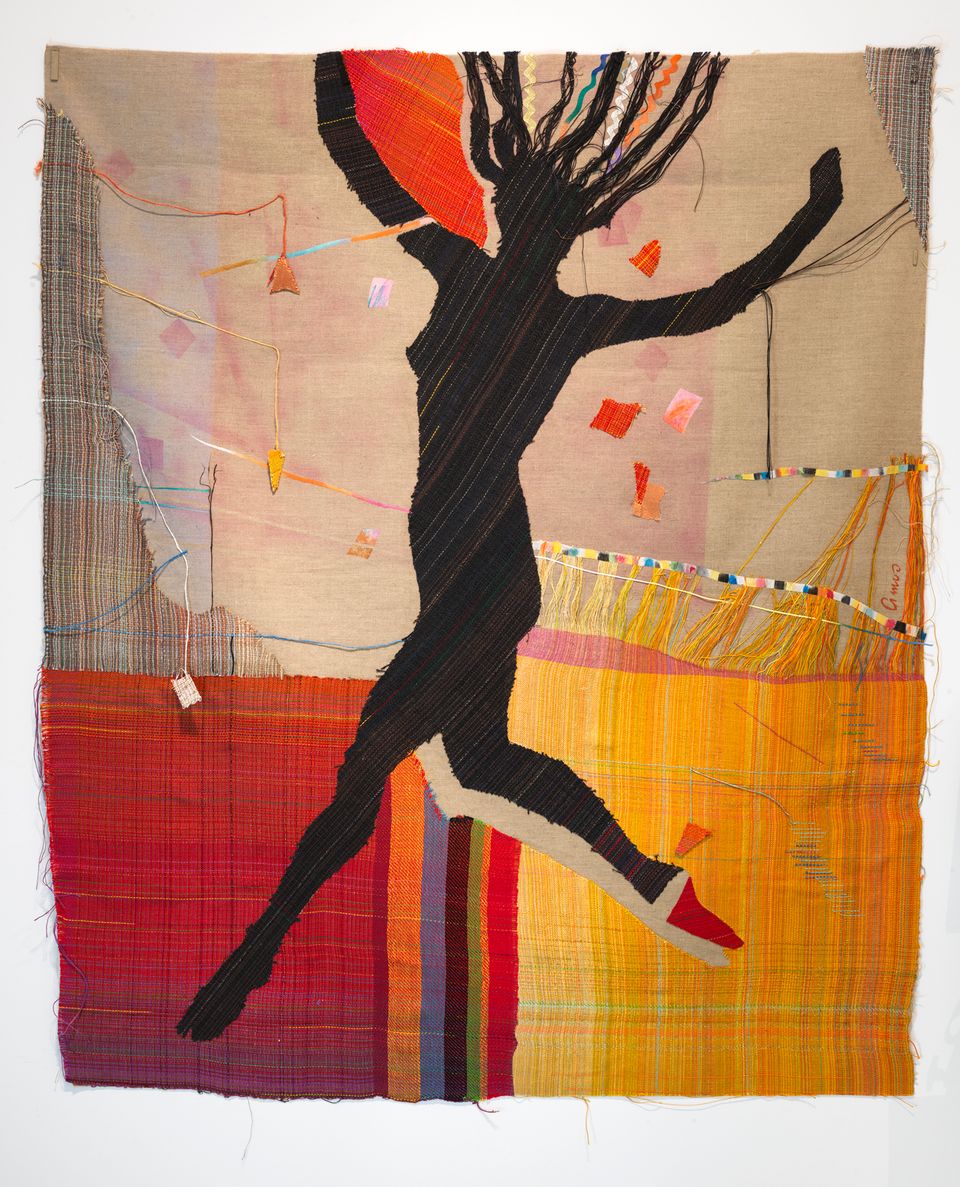 Fiber art with a silhouette of woman. Her arms and one leg are raised as if mid-jump.
