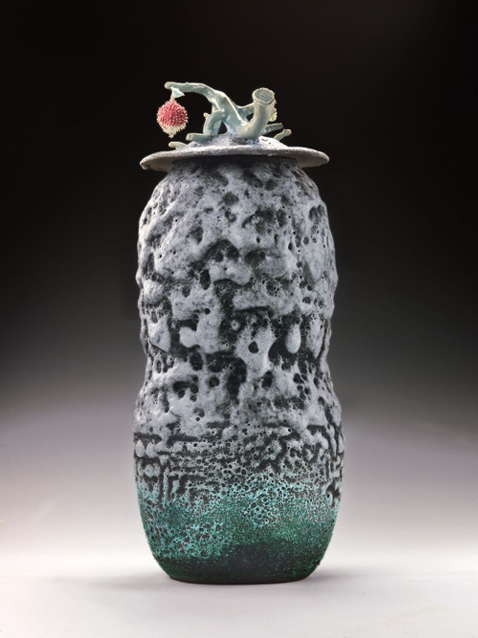 Lee's porcelain urn with a lychee fruit attached at the top.