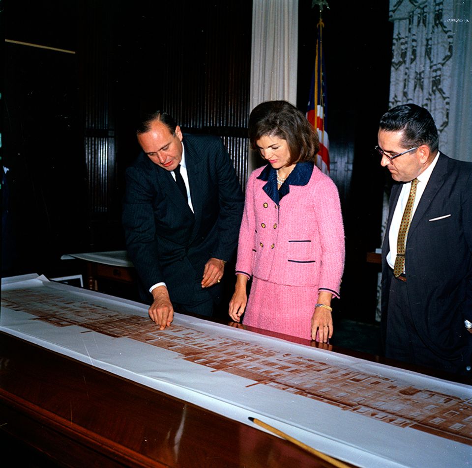 Jackie Kennedy looking at architectural drawings