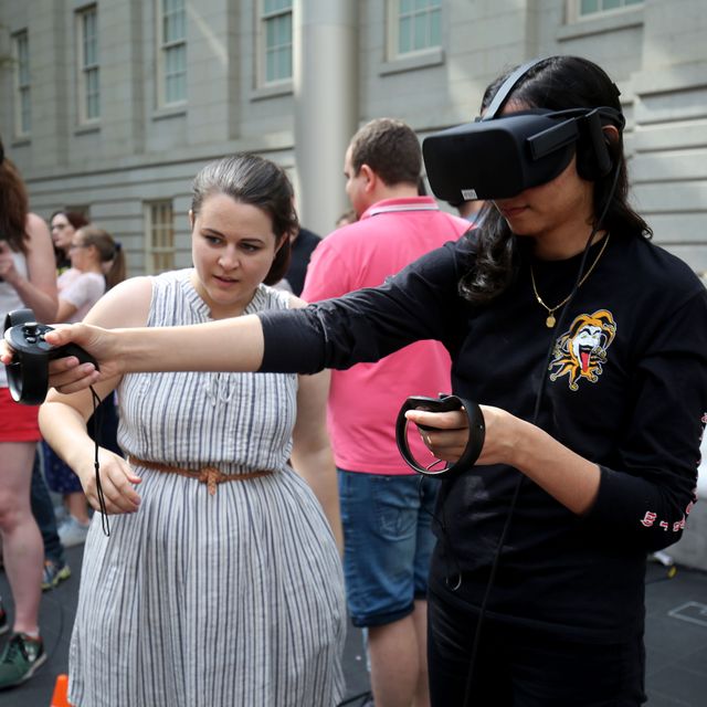 An image of a woman trying a VR (virtual reality) headset