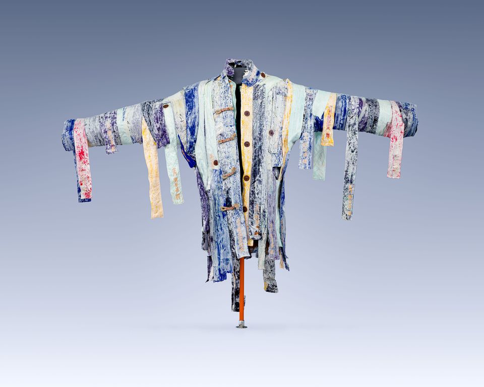 A sculptural jacket made of strips of fabric, which hang down.