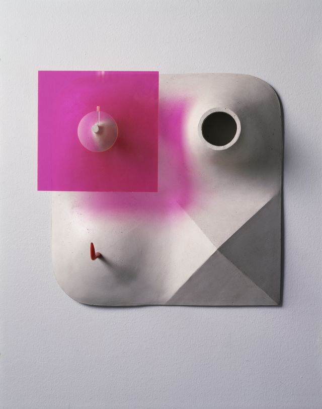 Sculpture giving a bird’s eye view of an abstracted landscape. A bright magenta square hovers above the top left section, casting a colorful shadow on the white foundation below. 