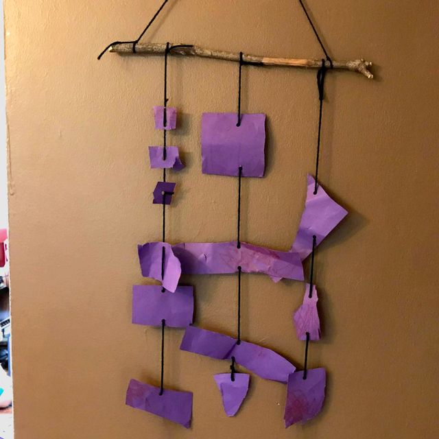A photograph of a purple hanging mobile.