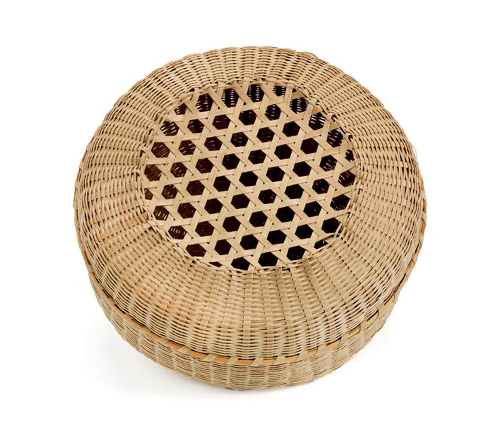 A basket with a circular base and lid with holes in the top.