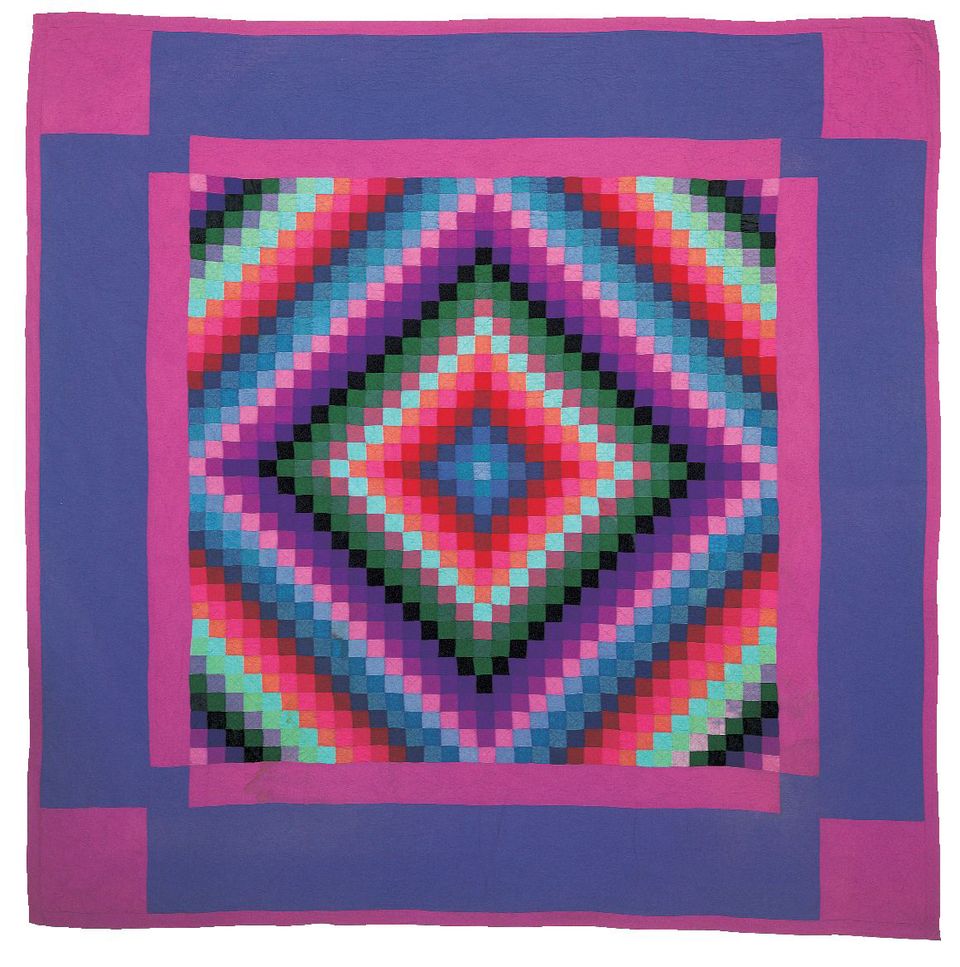 A colorful quilt with pink, purple, green and red. 