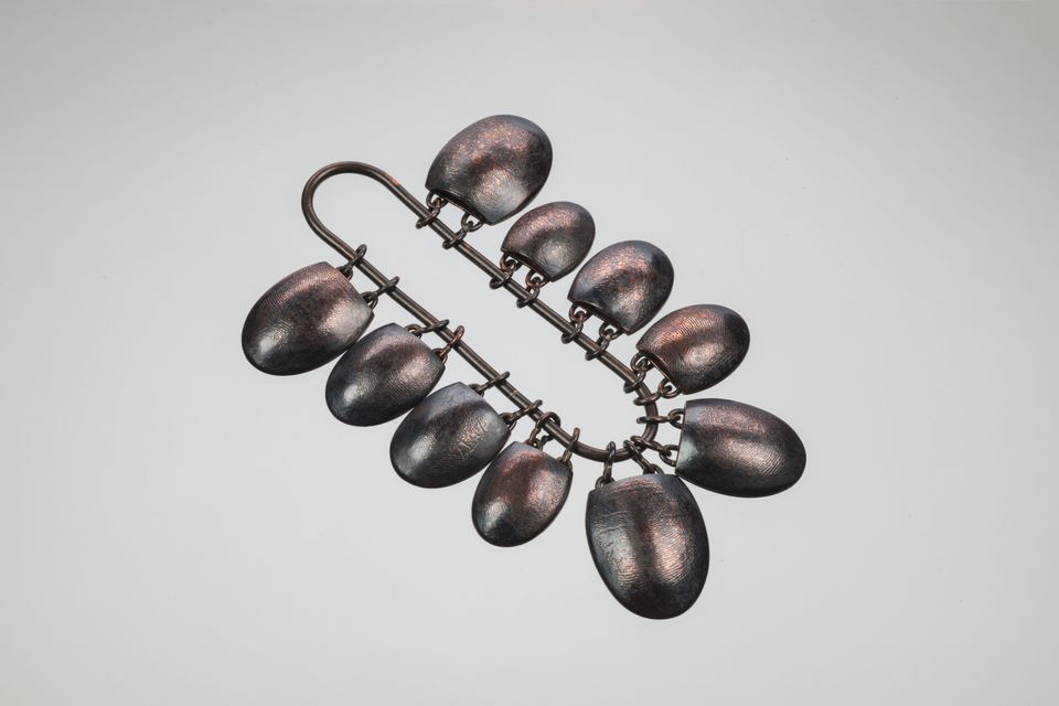 Coper oval adornments on a chain 