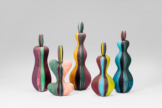 Five colorful ceramic bottles.