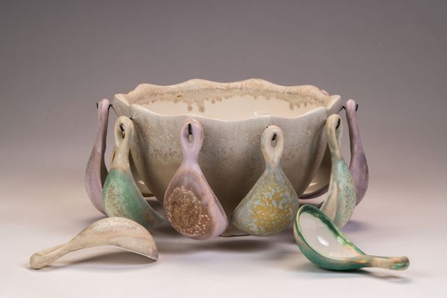 ceramic bowl with small spoons attached on the exterior 