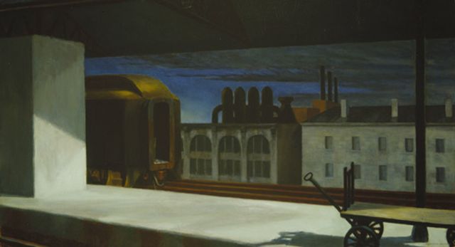Hopper's oil painting of train station with buildings in the background.