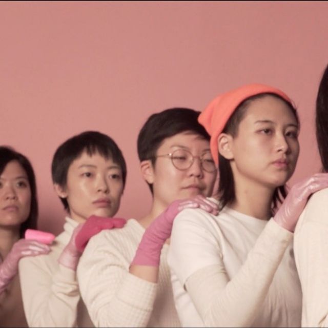 An image of six women each with a hand filled with pink slime