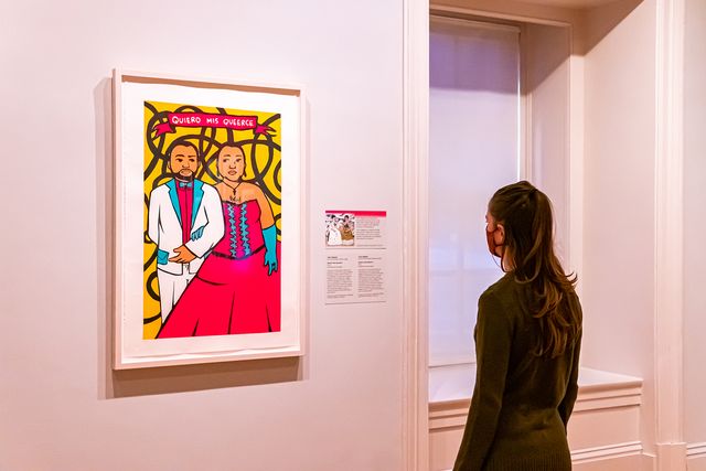 A photograph of a person looking at artwork