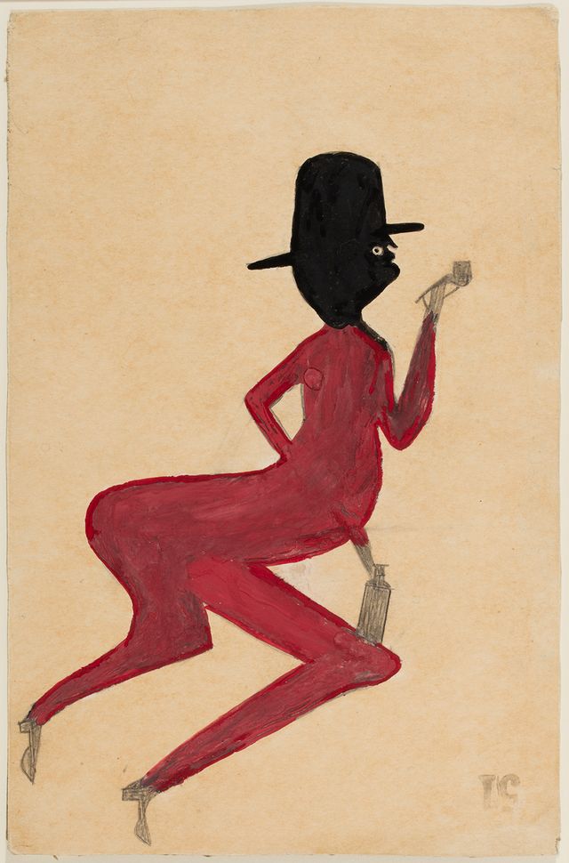 This is an image of a man painting in red with a black head and hat.