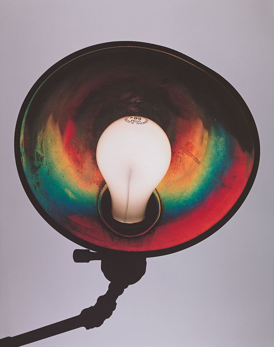 A photograph of the underside of a lamp with a prism of colors.