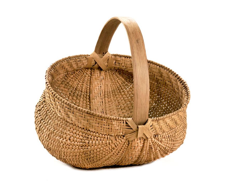 A basket that's short with a circular base and handle.