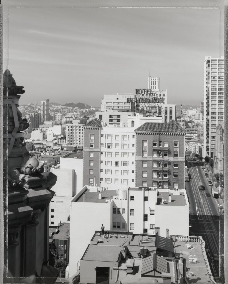 A photograph taken from the roof of a building looking out into the neighborhood.