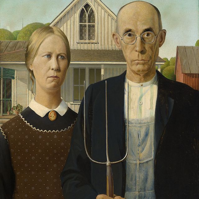 An image of a woman and a man with a house behind them. The man is holding a rake.