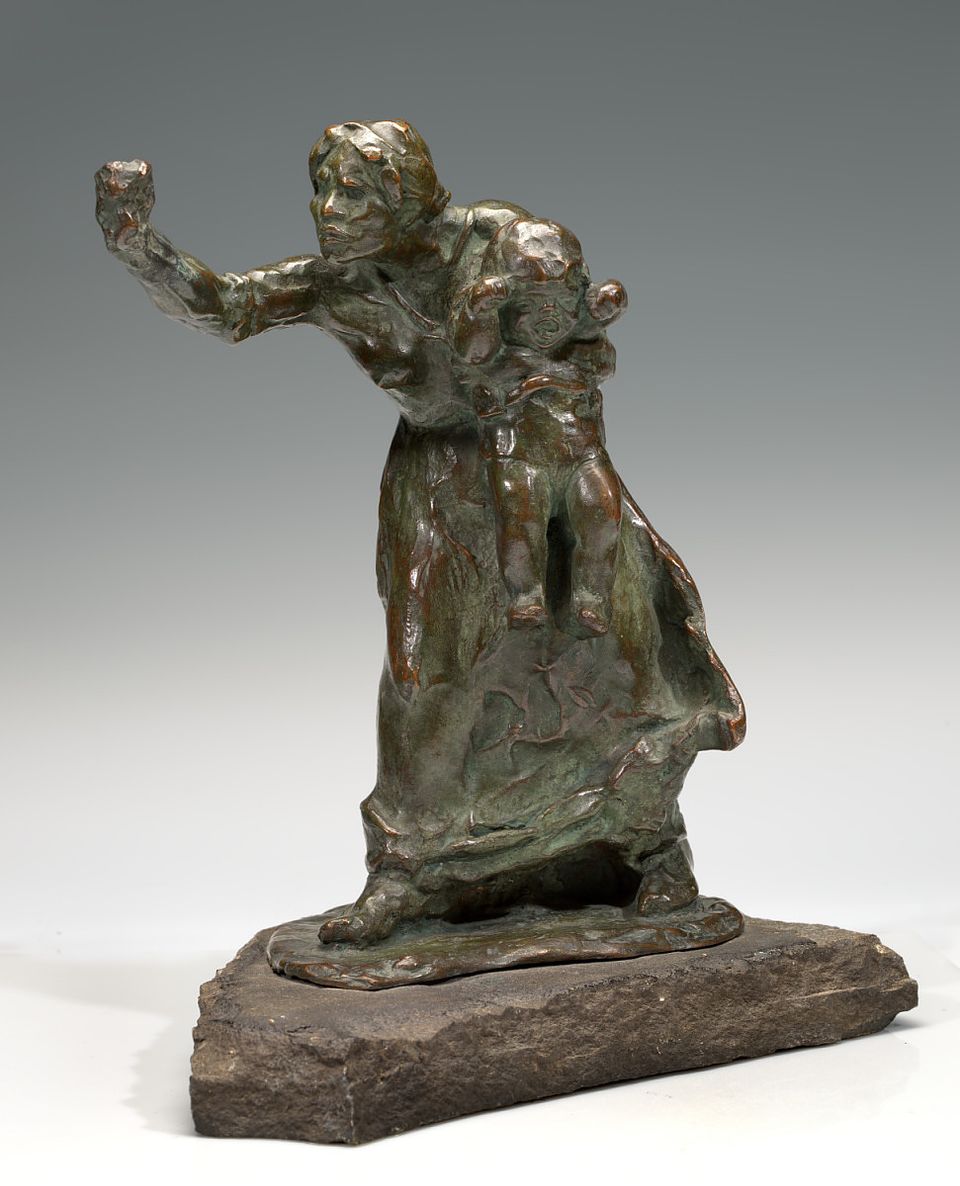 Small, bronze statue of a woman holding a child with her fist out