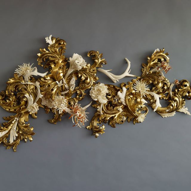 An image of a sculpture made of various materials and painted gold. 