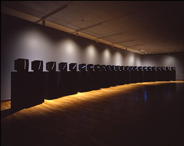 Name June Paik's TV Clock made from color television monitors mounted on twenty-four pedestals.