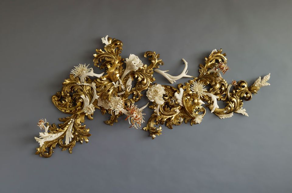 Wood fragments and antler, bone, and teeth painted in gold.
