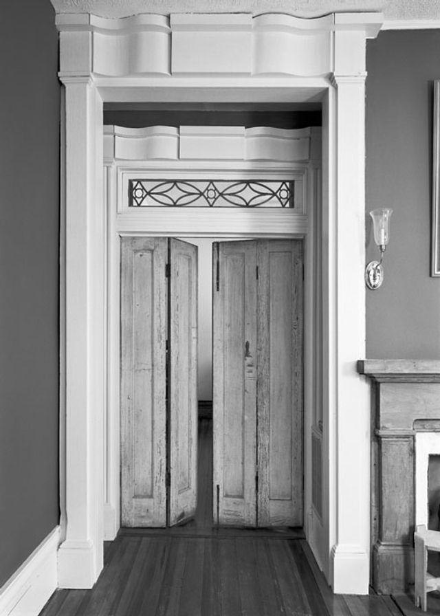 A photograph of a doorway with double swinging doors. 