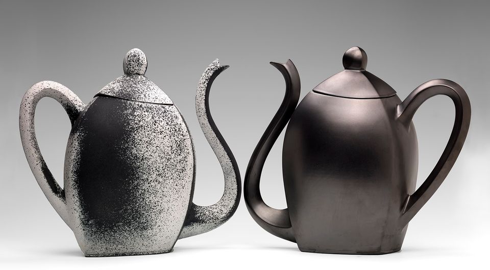Two ceramic teapots in black.