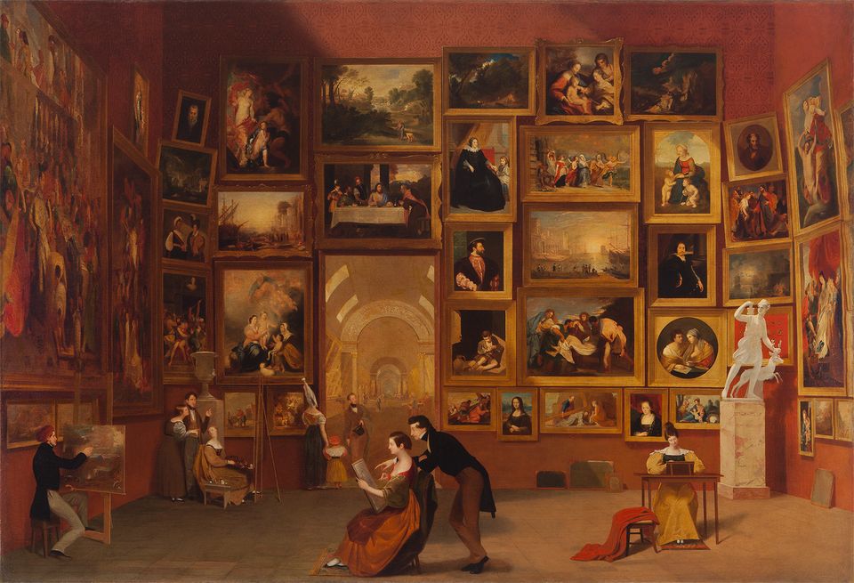 A room with many framed artworks on the walls.