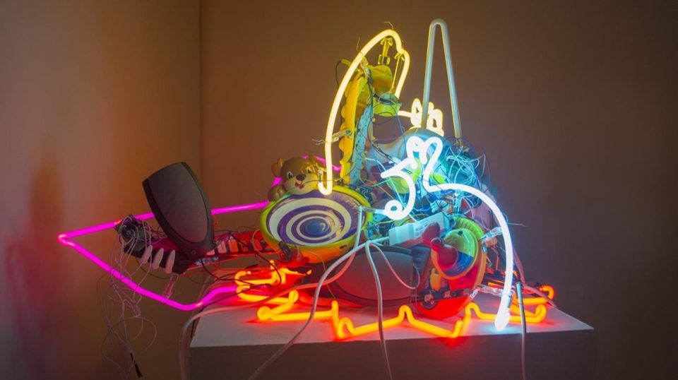 collection of neon lights with stuffed animals and computer parts bundled together