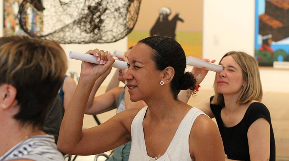 Teachers use rolled pieces of paper as telescopes.