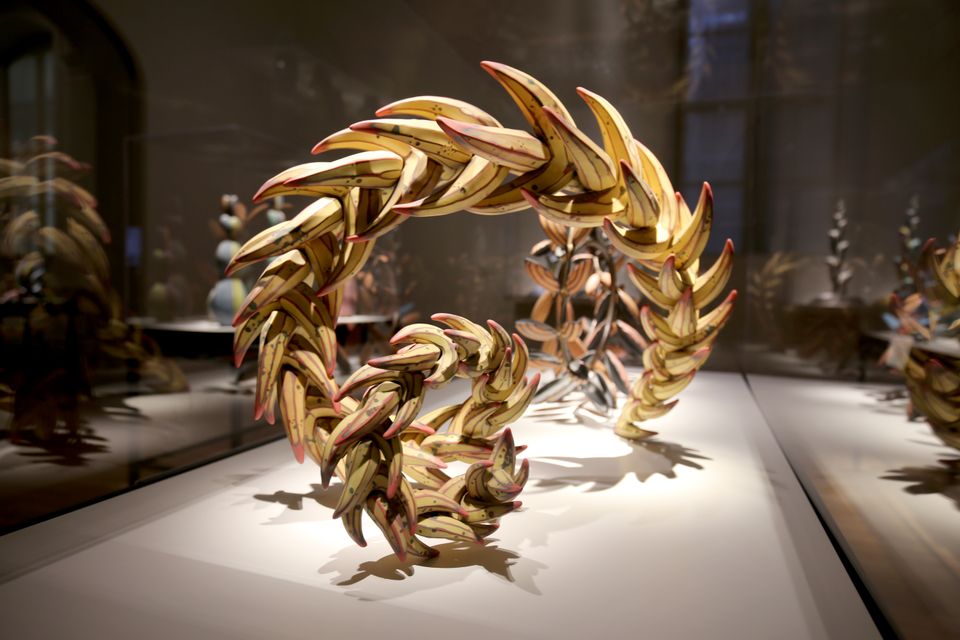 A detailed photograph of a yellow twisting sculpture. 
