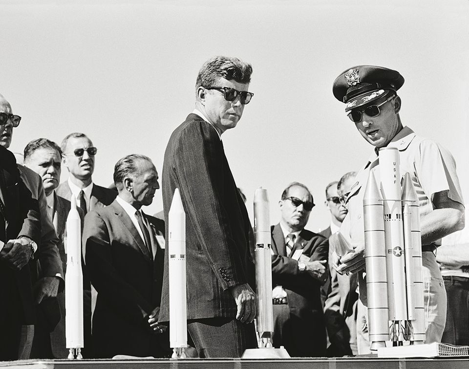 JFK next to a row of model rockets
